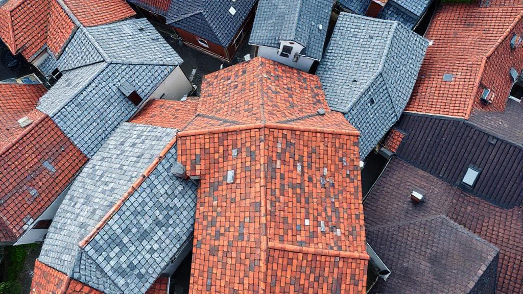 A detailed aerial view of various roofing materials and styles, showcasing the diversity and complexity of roofing options.